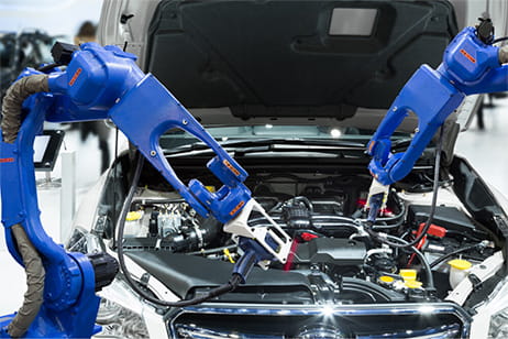Two robot arms inspecting a car