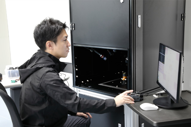 Two male developers testing the performance of optical equipment